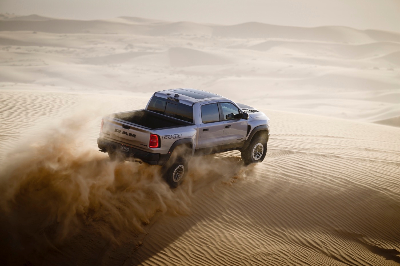 3/4 rear view of the high-performance 2025 RAM 1500 in a desert.